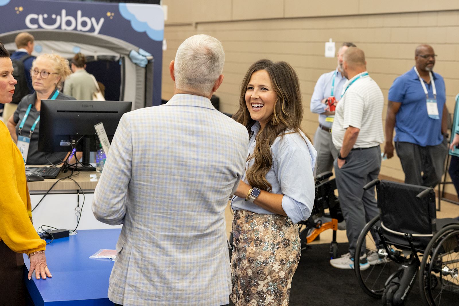 VGM team member laughing with members in the exhibit hall